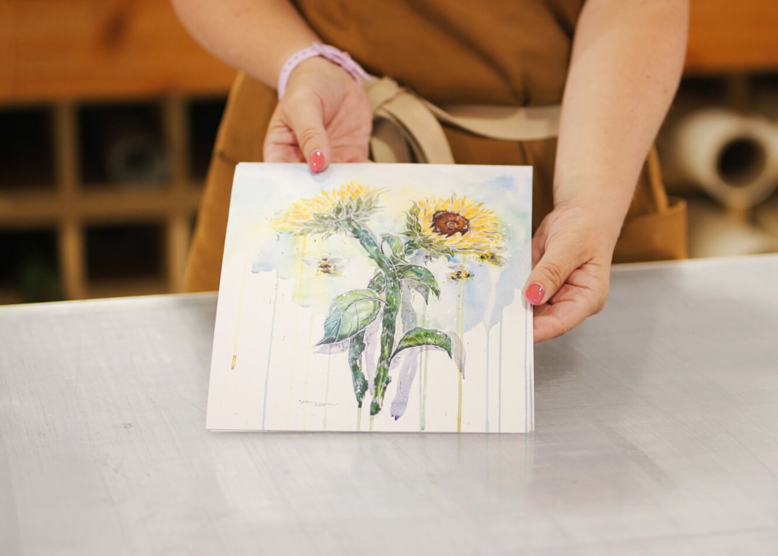 Studio worker holding a floral giclée paper print